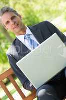 Confident businessman using laptop