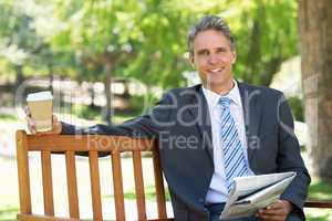 Businessman with newspaper and coffee cup