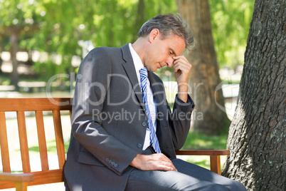 Depressed businessman in park