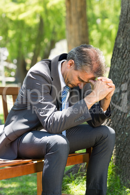 Disappointed businessman in park