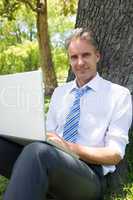 Confident mature businessman with laptop