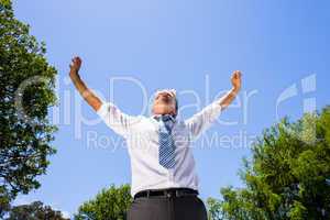 Successful businessman with arms outstretched