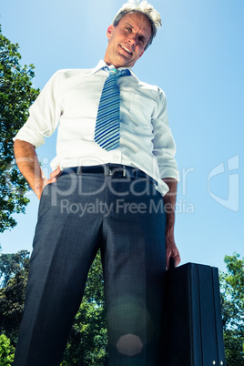 Confident businessman carrying briefcase