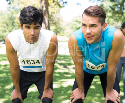 Tired marathon runners in park