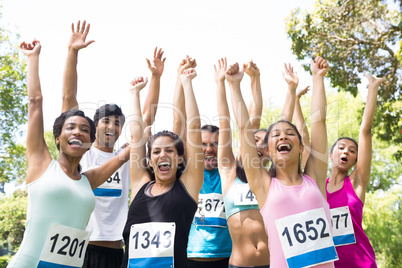 Marathon runners cheering in park