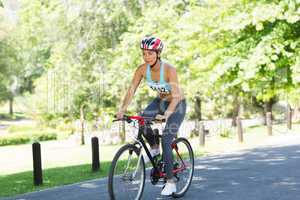 Female cyclist riding bicycle