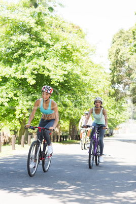 Sporty women riding bicycles