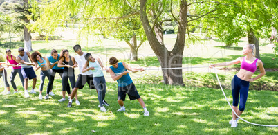 Woman playing tug of war with friends