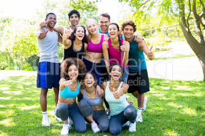 Friends in sportswear showing thumbs up