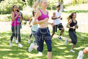 Athletes running on grassy land