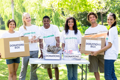 Confident volunteers with donation boxes