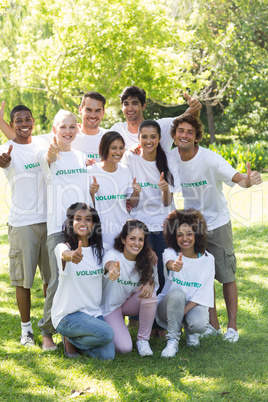 Volunteers showing thumbs up in park