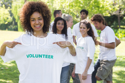 Happy volunteer pointing at tshirt