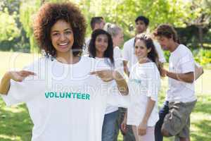 Happy volunteer pointing at tshirt