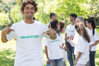 Portrait of volunteer pointing at tshirt