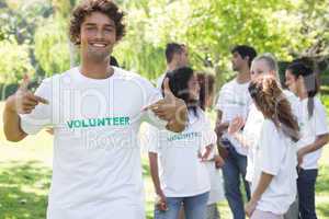 Portrait of volunteer pointing at tshirt