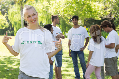 Beautiful volunteer pointing at tshirt