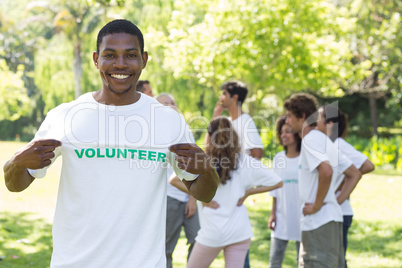 Portrait of happy volunteer holding tshirt