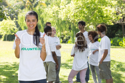 Volunteer gesturing thumbs up at park