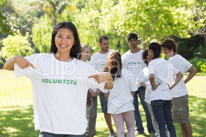 Beautiful volunteer pointing at tshirt