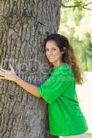 Environmentalist embracing tree trunk