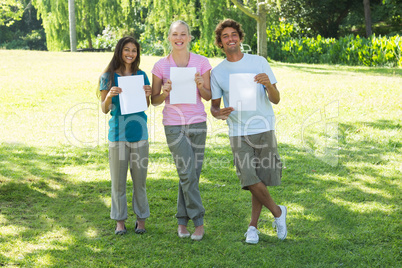 Friends holding blank papers