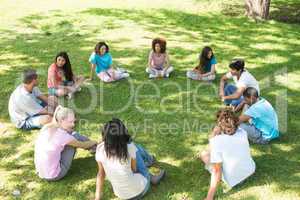 Friends sitting in a circle at park