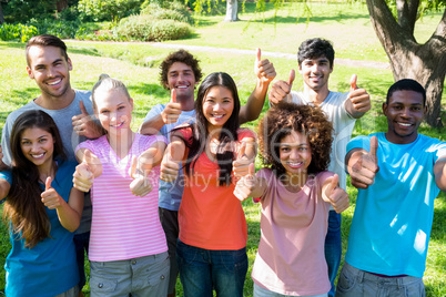 Happy friends gesturing thumbs up