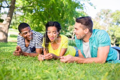 Friends lying on grass at campus