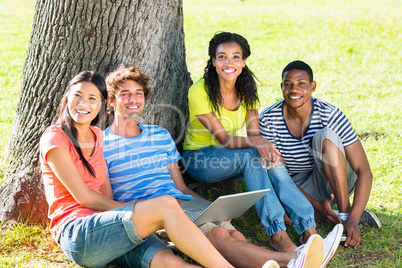 Happy students with laptop on campus