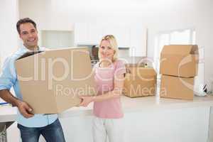 Smiling couple moving together in a new house