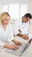 Couple with bills and laptop in the kitchen