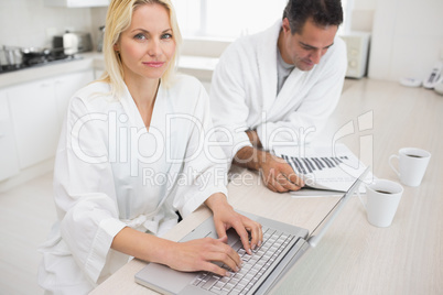 Couple with bills and laptop in the kitchen