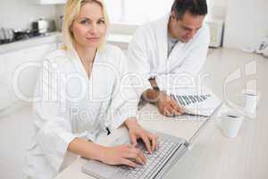 Couple with bills and laptop in the kitchen