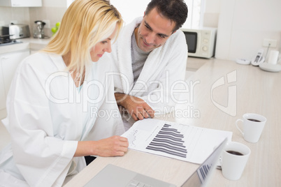 Couple with bills and laptop in kitchen
