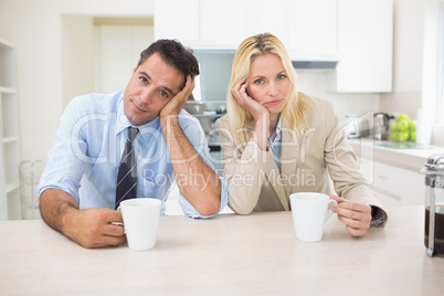 Portrait of well dressed couple  with coffee cups in kitchen