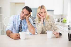 Portrait of well dressed couple  with coffee cups in kitchen