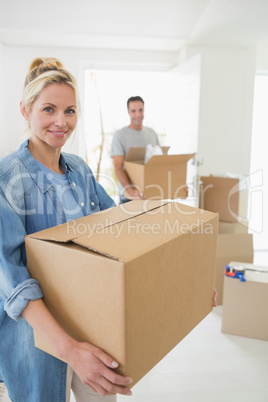 Smiling couple moving together in a new house