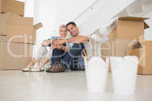 Takeaway food with couple and boxes at new house