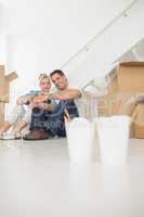 Takeaway food with couple and boxes at new house