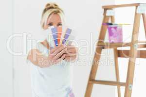 Blurred woman holding color swatches in a new house