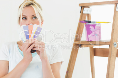 Woman holding color swatches in new house