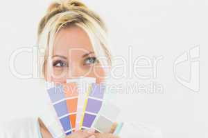 Closeup of a beautiful young woman holding color swatches