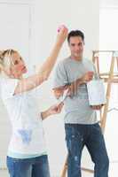 Couple with color swatches and ladder in a new house
