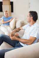 Relaxed couple sitting on sofa in the living room