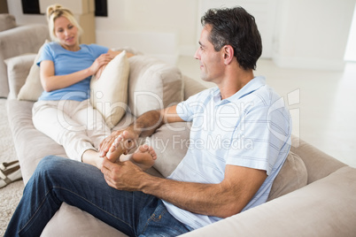 Relaxed couple sitting on sofa in living room