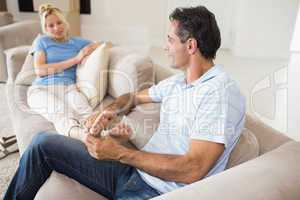 Relaxed couple sitting on sofa in living room