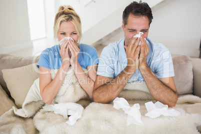 Couple suffering from cold in bed