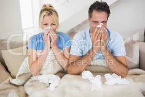 Couple suffering from cold in bed