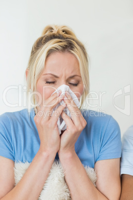 Closeup of a young woman suffering from cold